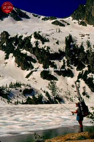 Skier Fly Fishing Alpine Lake